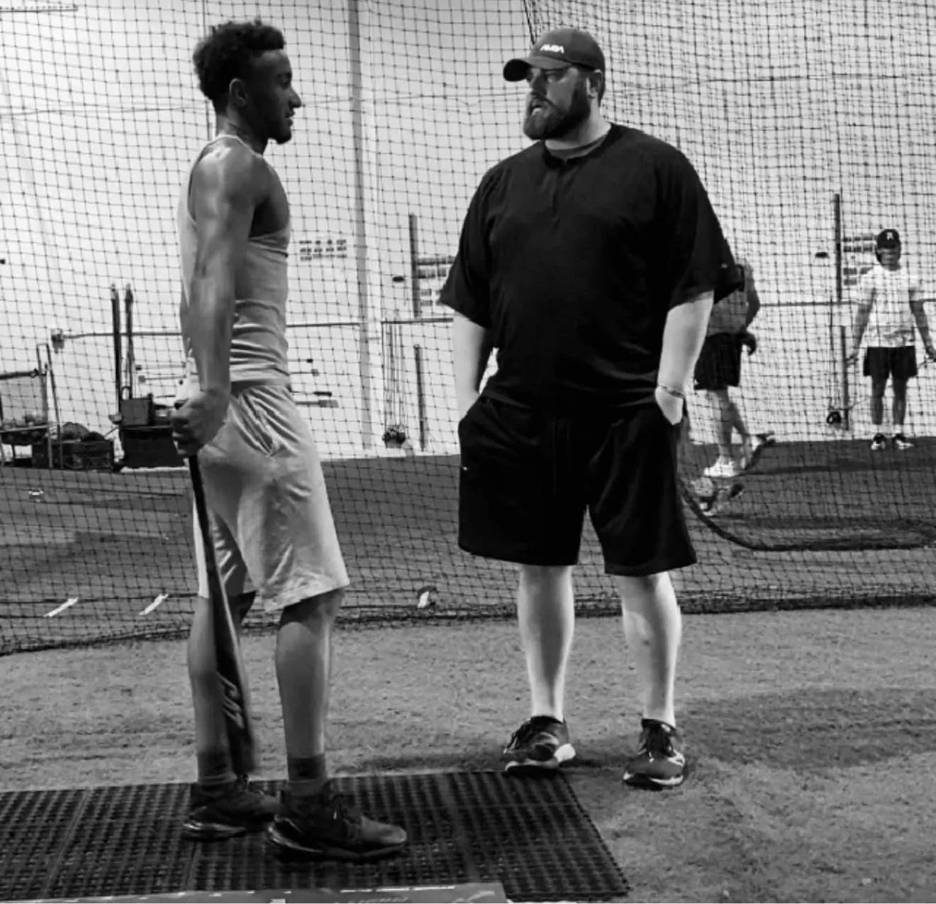 Geoff Rottmayer coaching a hitter in the cage